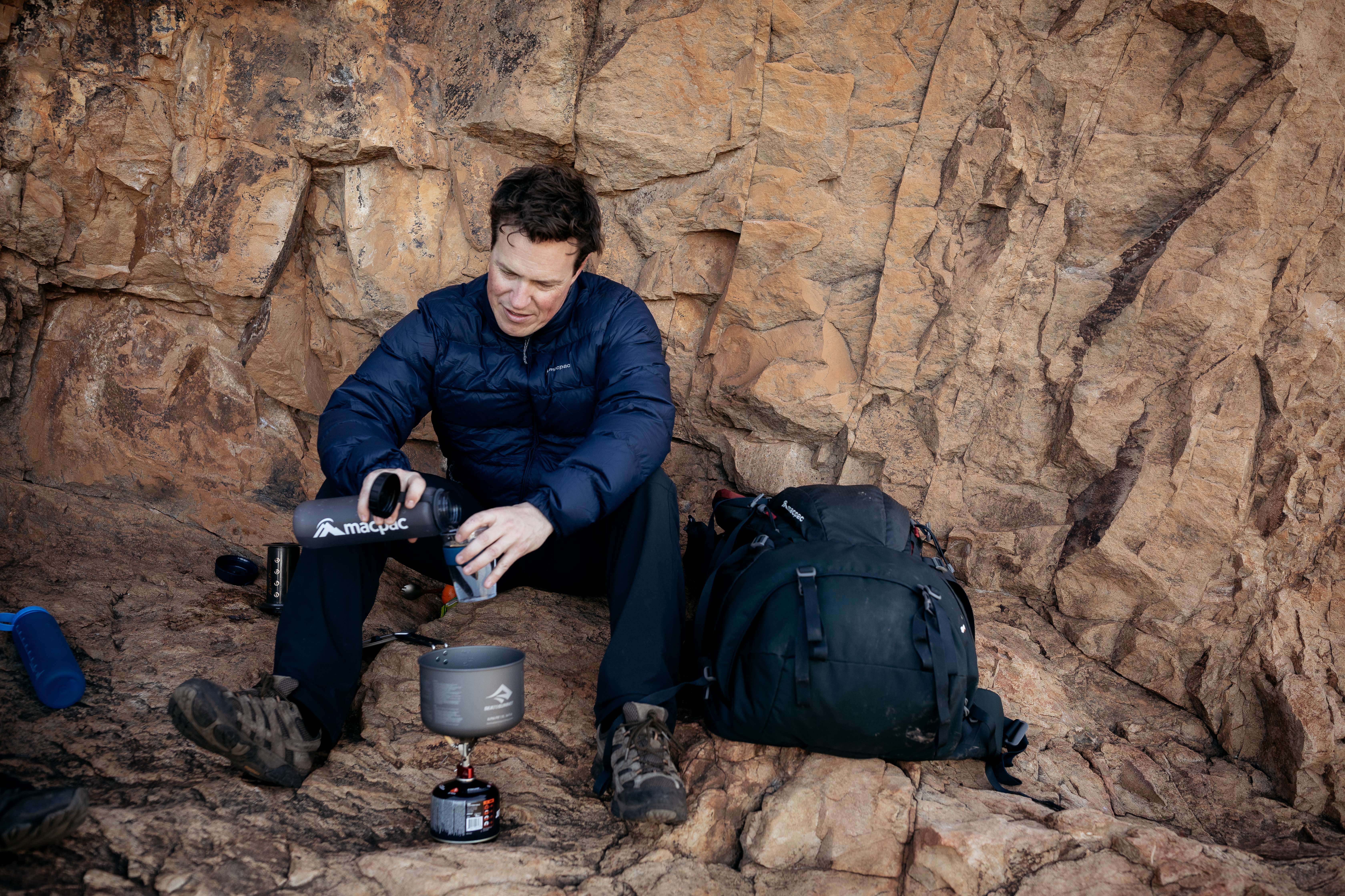 Hiking gear Man making a coffee during hike